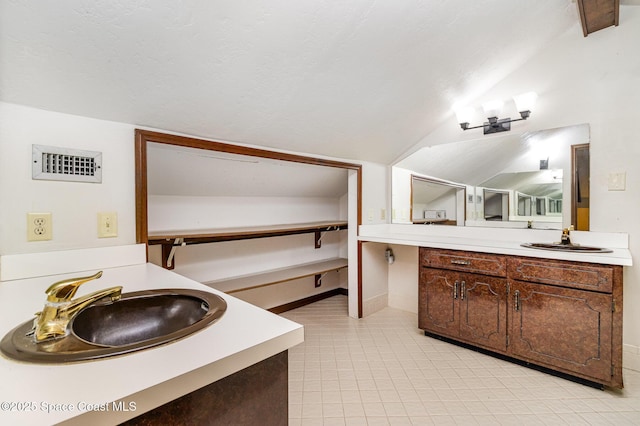 4121 Mustang Rd, Melbourne, FL 32934 - bathroom featuring lofted ceiling, vanity, baseboards, and tile patterned floors