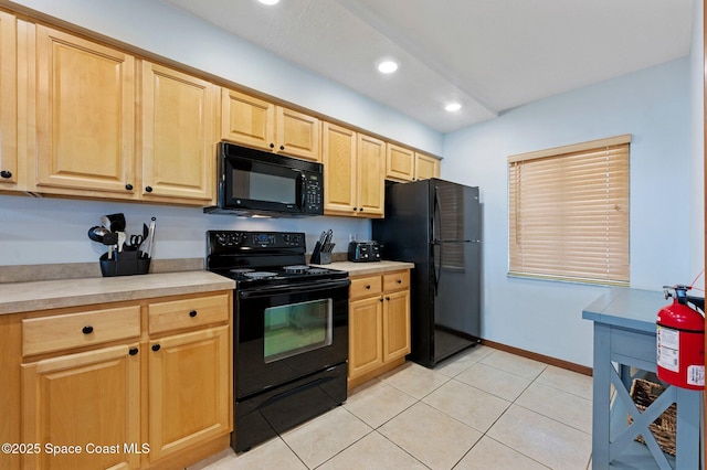 1000 N Atlantic Ave Unit 614, Cocoa Beach, FL 32931 - kitchen with black appliances, light brown cabinets, light countertops, light tile patterned floors, and recessed lighting
