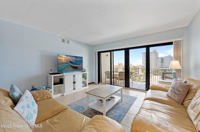 1000 N Atlantic Ave Unit 614, Cocoa Beach, FL 32931 - living room with light tile patterned floors and a textured ceiling