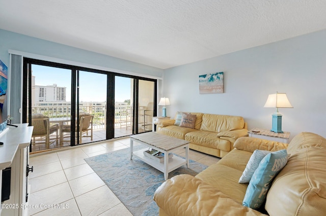 1000 N Atlantic Ave Unit 614, Cocoa Beach, FL 32931 - living area with light tile patterned flooring and a textured ceiling