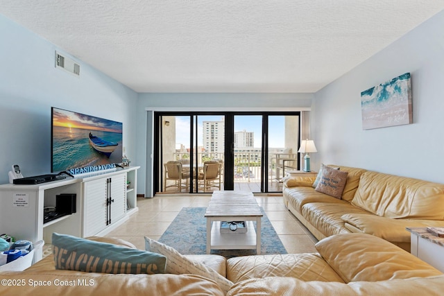 1000 N Atlantic Ave Unit 614, Cocoa Beach, FL 32931 - living area with light tile patterned floors and a textured ceiling