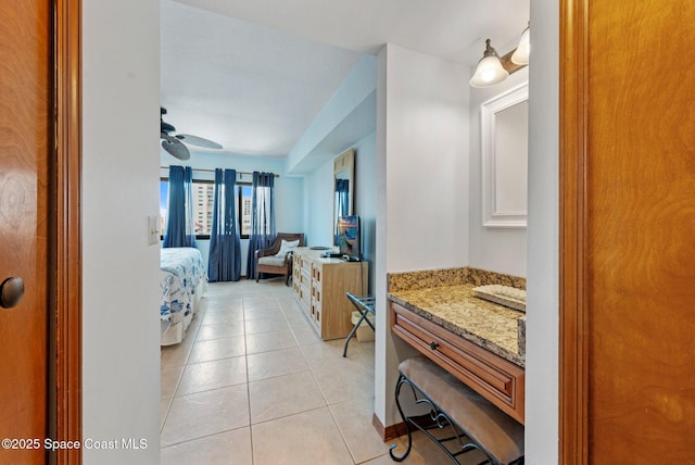 1000 N Atlantic Ave Unit 614, Cocoa Beach, FL 32931 - ensuite bathroom featuring vanity, tile patterned flooring, and a ceiling fan