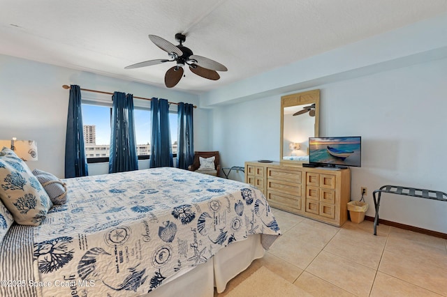 1000 N Atlantic Ave Unit 614, Cocoa Beach, FL 32931 - bedroom featuring light tile patterned floors, a ceiling fan, baseboards, and a textured ceiling
