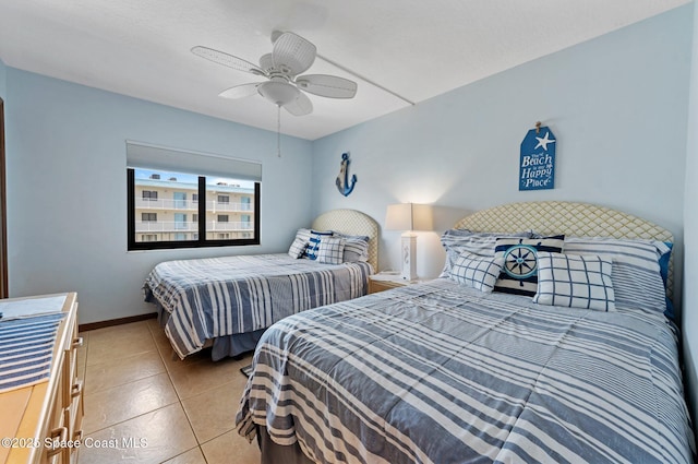 1000 N Atlantic Ave Unit 614, Cocoa Beach, FL 32931 - bedroom with tile patterned floors, a ceiling fan, and baseboards