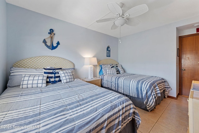 1000 N Atlantic Ave Unit 614, Cocoa Beach, FL 32931 - bedroom with light tile patterned floors and ceiling fan