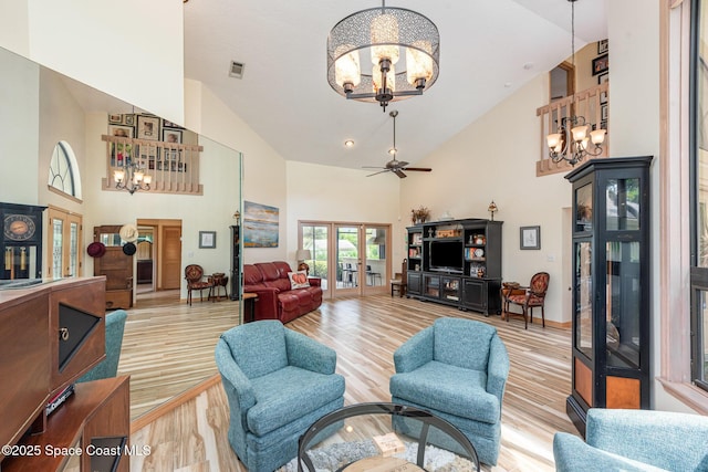 3750 Shady Run Rd, Melbourne, FL 32934 - living area featuring a chandelier, high vaulted ceiling, french doors, light wood-style floors, and a ceiling fan
