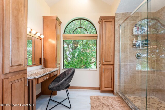 3750 Shady Run Rd, Melbourne, FL 32934 - bathroom with lofted ceiling, a stall shower, and baseboards