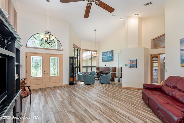 3750 Shady Run Rd, Melbourne, FL 32934 - foyer featuring a chandelier, high vaulted ceiling, a ceiling fan, light wood-style flooring, and baseboards