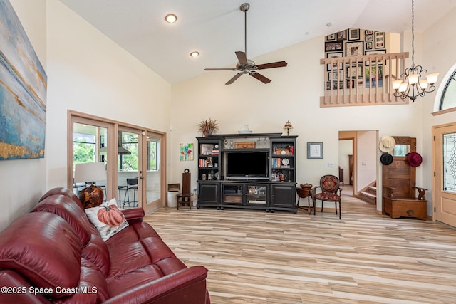 3750 Shady Run Rd, Melbourne, FL 32934 - living room featuring high vaulted ceiling, light wood-style floors, a chandelier, ceiling fan, and stairway