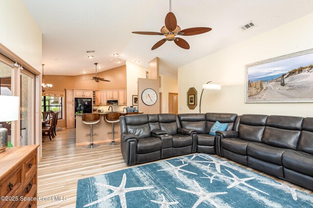 3750 Shady Run Rd, Melbourne, FL 32934 - living area with a ceiling fan, light wood-style floors, lofted ceiling, and a chandelier