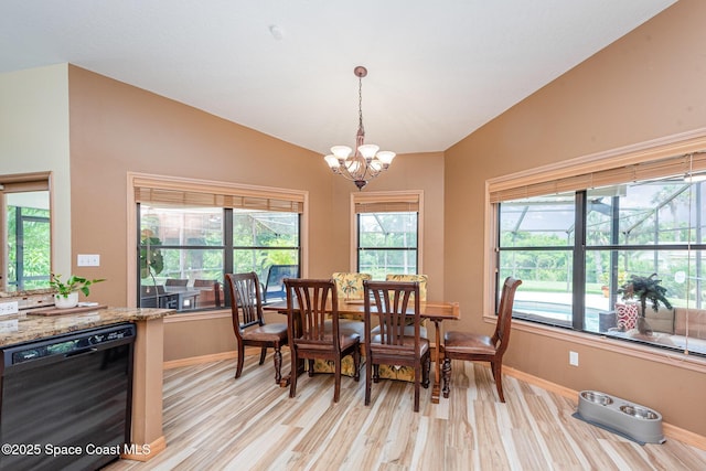 3750 Shady Run Rd, Melbourne, FL 32934 - dining space featuring lofted ceiling, light wood-style flooring, a chandelier, and baseboards
