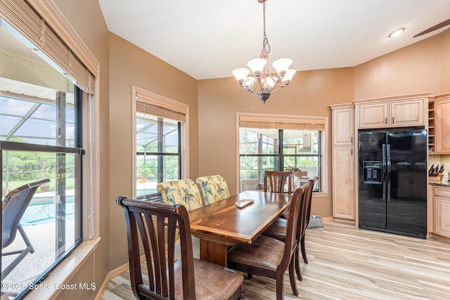 3750 Shady Run Rd, Melbourne, FL 32934 - dining area featuring a chandelier, healthy amount of natural light, and light wood-type flooring