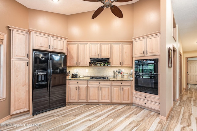 3750 Shady Run Rd, Melbourne, FL 32934 - kitchen featuring black appliances, light brown cabinetry, a ceiling fan, decorative backsplash, and a high ceiling