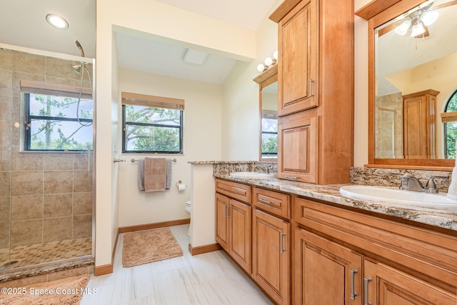 3750 Shady Run Rd, Melbourne, FL 32934 - full bathroom featuring double vanity, a shower stall, toilet, and baseboards