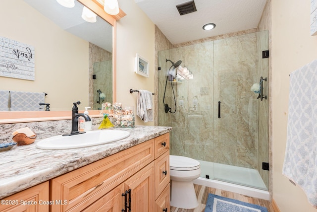 3750 Shady Run Rd, Melbourne, FL 32934 - full bathroom with vanity, a stall shower, toilet, and wood finished floors