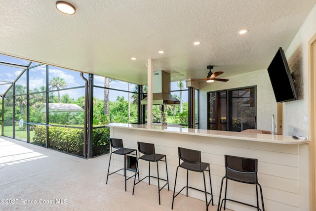 3750 Shady Run Rd, Melbourne, FL 32934 - kitchen featuring a textured ceiling, a ceiling fan, a sunroom, recessed lighting, and island exhaust hood