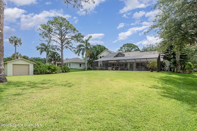 3750 Shady Run Rd, Melbourne, FL 32934 - view of green lawn with an outdoor structure, a garage, and a lanai