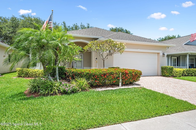 638 Brockton Way W, Melbourne, FL 32904 - view of front of home featuring stucco siding, a garage, decorative driveway, and a front lawn