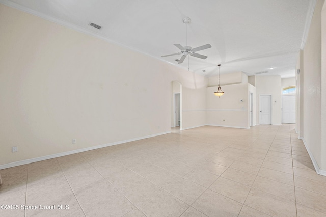 638 Brockton Way W, Melbourne, FL 32904 - spare room featuring a ceiling fan, ornamental molding, arched walkways, light tile patterned floors, and baseboards