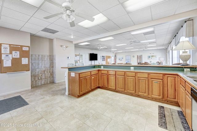 638 Brockton Way W, Melbourne, FL 32904 - kitchen featuring a ceiling fan, a paneled ceiling, dishwasher, brown cabinets, and light countertops