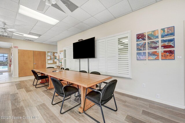 638 Brockton Way W, Melbourne, FL 32904 - dining area with a ceiling fan, light wood-style floors, a paneled ceiling, and baseboards