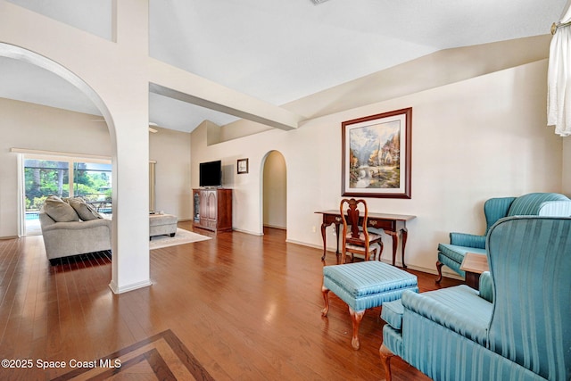 1068 Egret Lake Way, Melbourne, FL 32940 - living area with arched walkways, wood finished floors, and baseboards