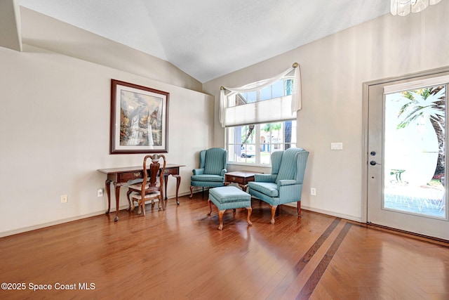 1068 Egret Lake Way, Melbourne, FL 32940 - sitting room with lofted ceiling, baseboards, and wood finished floors