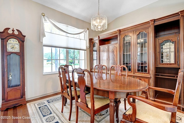 1068 Egret Lake Way, Melbourne, FL 32940 - dining space featuring a chandelier, wood finished floors, and baseboards