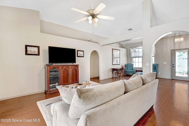 1068 Egret Lake Way, Melbourne, FL 32940 - living area featuring arched walkways, wood finished floors, plenty of natural light, a ceiling fan, and vaulted ceiling