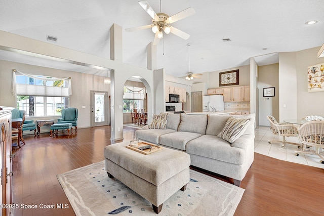 1068 Egret Lake Way, Melbourne, FL 32940 - living room with a ceiling fan, arched walkways, light wood finished floors, recessed lighting, and high vaulted ceiling
