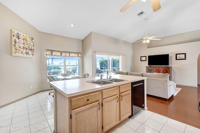 1068 Egret Lake Way, Melbourne, FL 32940 - kitchen featuring a ceiling fan, light tile patterned flooring, open floor plan, black dishwasher, and high vaulted ceiling