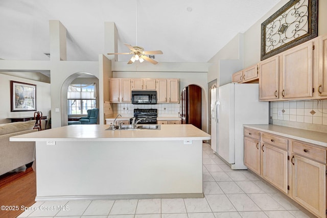1068 Egret Lake Way, Melbourne, FL 32940 - kitchen with black appliances, arched walkways, light brown cabinets, a ceiling fan, and a sink