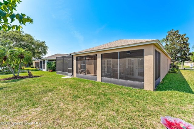1223 Brumpton Pl, Rockledge, FL 32955 - rear view of house with a sunroom, a yard, and stucco siding