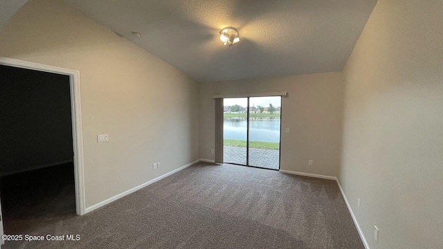 975 Luminary Cir Unit 103, Melbourne, FL 32901 - unfurnished room featuring vaulted ceiling, carpet flooring, baseboards, and a water view