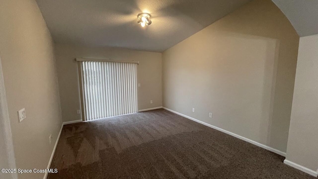 975 Luminary Cir Unit 103, Melbourne, FL 32901 - spare room with dark colored carpet, baseboards, and vaulted ceiling