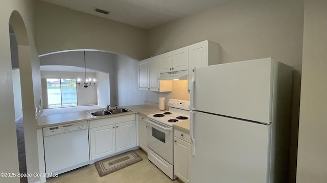 975 Luminary Cir Unit 103, Melbourne, FL 32901 - kitchen with white appliances, a sink, under cabinet range hood, and arched walkways