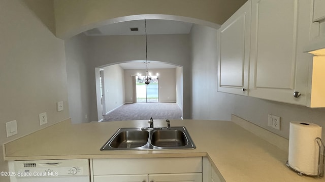 975 Luminary Cir Unit 103, Melbourne, FL 32901 - kitchen with a sink, white dishwasher, a chandelier, light countertops, and arched walkways