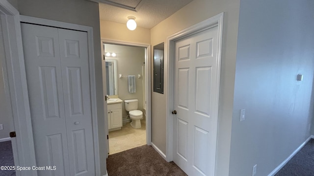 975 Luminary Cir Unit 103, Melbourne, FL 32901 - bathroom featuring vanity, a closet, baseboards, toilet, and a textured ceiling