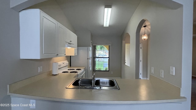 975 Luminary Cir Unit 103, Melbourne, FL 32901 - kitchen with white appliances, arched walkways, a sink, under cabinet range hood, and a peninsula