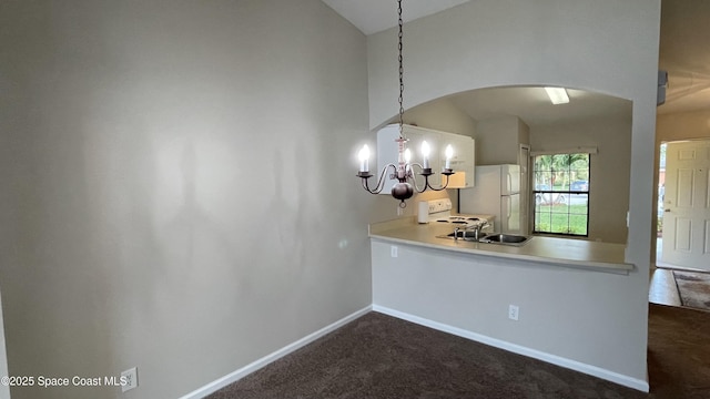 975 Luminary Cir Unit 103, Melbourne, FL 32901 - kitchen featuring white appliances, lofted ceiling, arched walkways, dark colored carpet, and baseboards