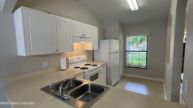 975 Luminary Cir Unit 103, Melbourne, FL 32901 - kitchen with white appliances, under cabinet range hood, a sink, vaulted ceiling, and white cabinetry