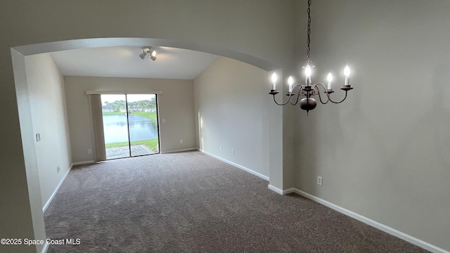 975 Luminary Cir Unit 103, Melbourne, FL 32901 - carpeted spare room featuring arched walkways, a chandelier, and baseboards