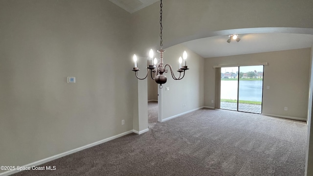 975 Luminary Cir Unit 103, Melbourne, FL 32901 - unfurnished room with arched walkways, carpet flooring, lofted ceiling, baseboards, and a chandelier