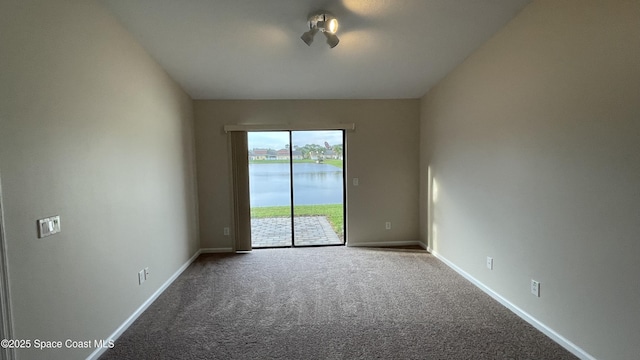 975 Luminary Cir Unit 103, Melbourne, FL 32901 - unfurnished room with carpet flooring, a water view, and baseboards