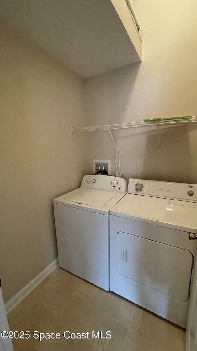 975 Luminary Cir Unit 103, Melbourne, FL 32901 - washroom featuring washer and dryer and baseboards
