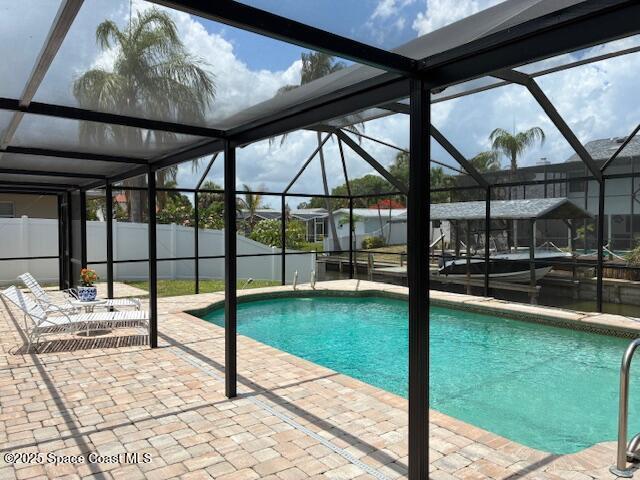 60 Alhambra Dr, Merritt Island, FL 32952 - swimming pool featuring a lanai and a patio area