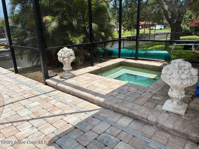 60 Alhambra Dr, Merritt Island, FL 32952 - view of pool featuring an in-ground hot tub, a lanai, and a patio