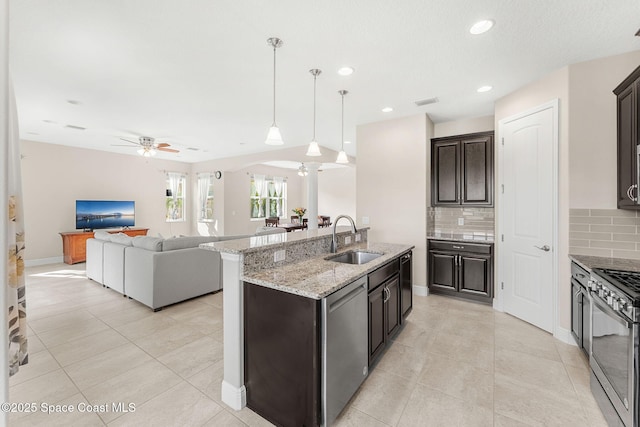 2810 Amethyst Way, Melbourne, FL 32940 - kitchen with stainless steel appliances, ceiling fan, decorative backsplash, arched walkways, and light tile patterned floors