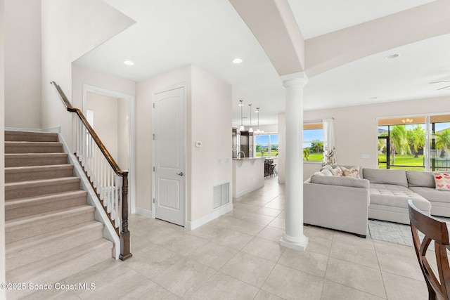 2810 Amethyst Way, Melbourne, FL 32940 - living area with decorative columns, stairs, recessed lighting, and light tile patterned floors