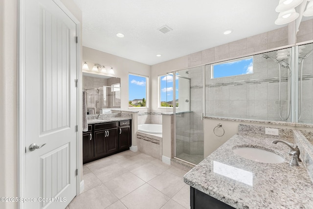 2810 Amethyst Way, Melbourne, FL 32940 - bathroom featuring two vanities, a stall shower, a bath, tile patterned flooring, and recessed lighting